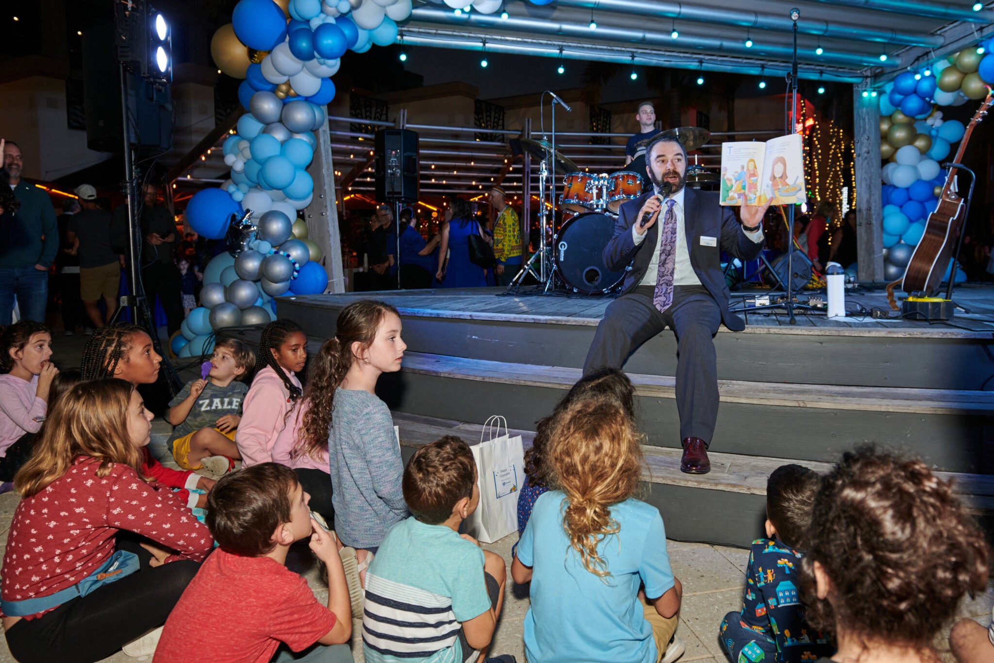 Rabbi Greg Weisman reads to kids at the Community-wide Chanukah Celebration in Boca