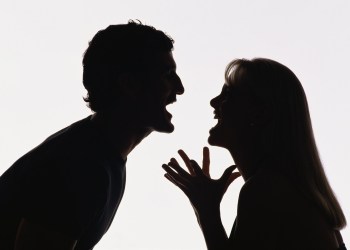 Silhouette of man and woman yelling at each other