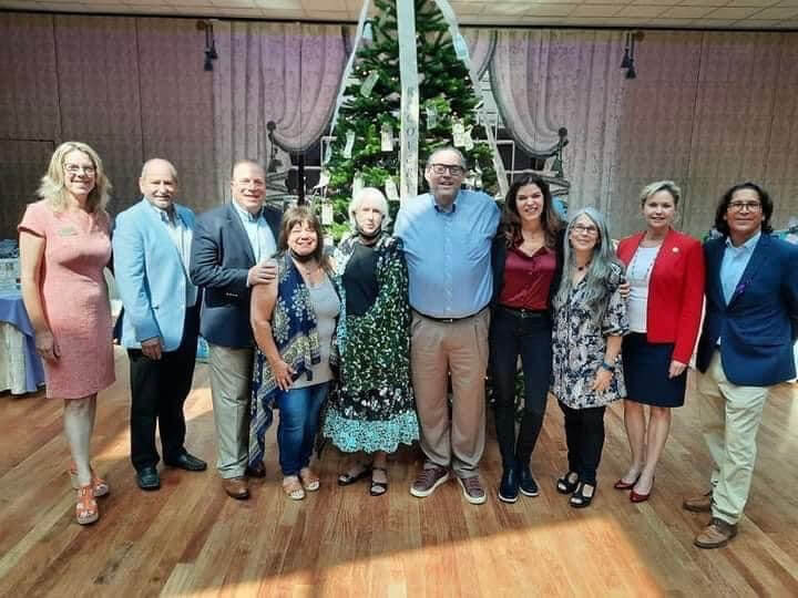 Last year’s fundraiser for Gabriel’s Giving Tree enabled the nonprofit to help many families with overdose funeral expenses. Here, attendees stand in front of the Angel Tree, which has ornaments with the faces and names of those lost to the opioid epidemic.