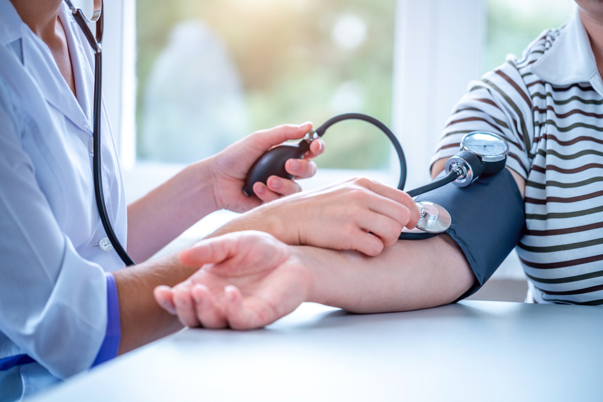 Doctor measures the pressure of the patient during a medical examination and consultation in the hospital