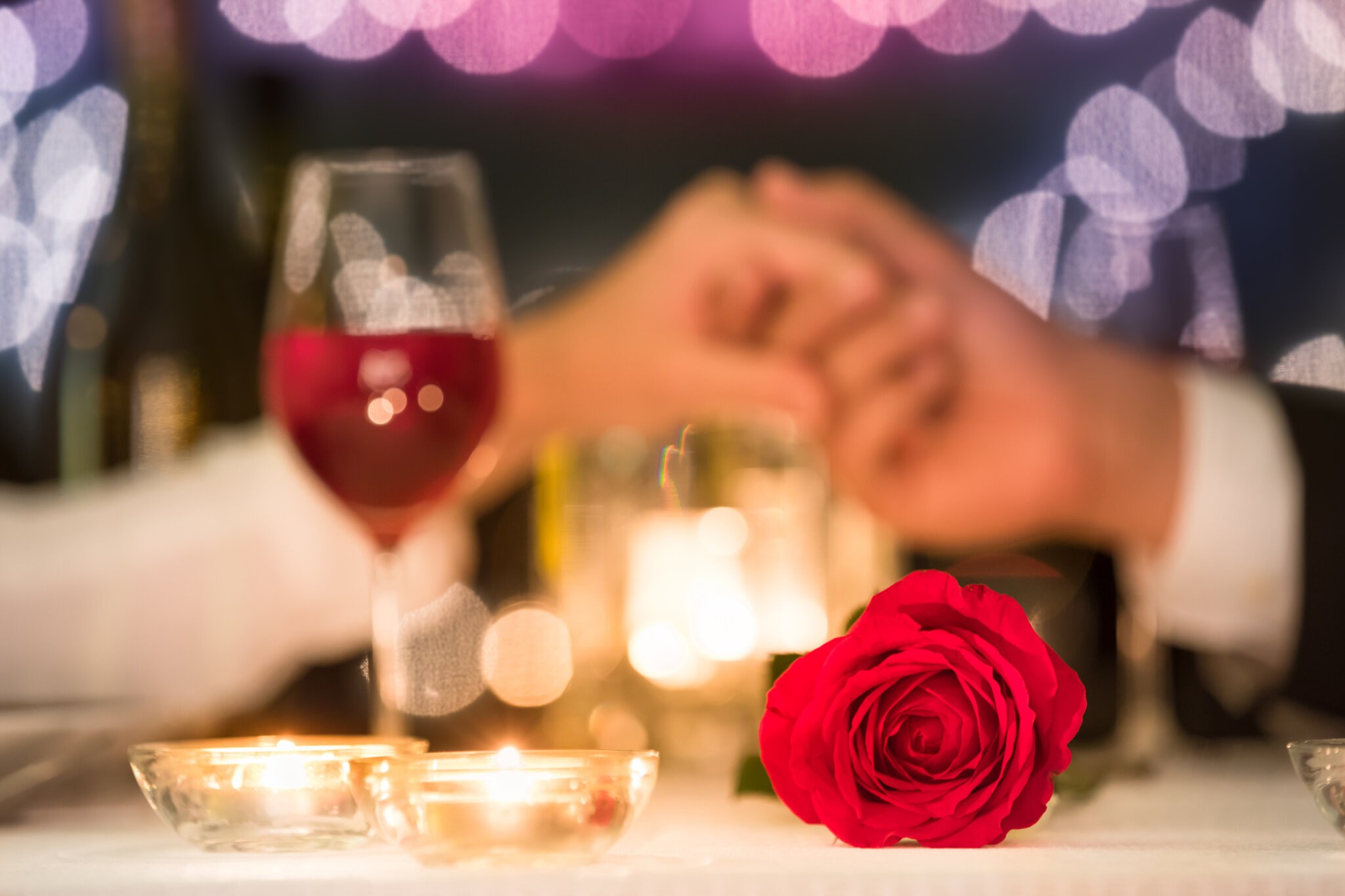 Couple holding hands, enjoy a romantic Valentine's meal on the North Fork