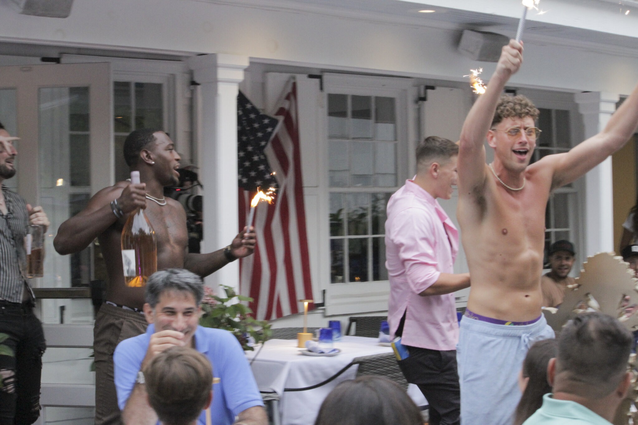 The men of 75 Main add some flare as they serve dishes at the LGBTQ event in the Hamptons Serving the Hamptons Season 2