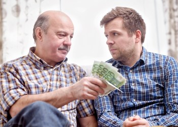 Elderly father lends money to his adult child son. He helps his child deal with financial problems.