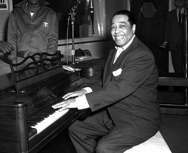 Duke Ellington, a famous jazz musician, poses with his piano at the KFG Radio Studio. KFG is Fitzsimons Army Medical Center's radio station