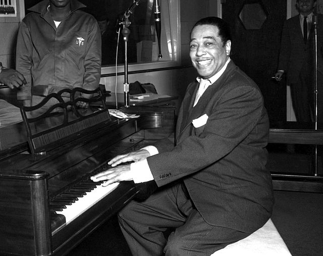 Duke Ellington, a famous jazz musician, poses with his piano at the KFG Radio Studio. KFG is Fitzsimons Army Medical Center's radio station