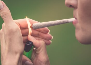 Close-up of woman smoking marijuana cannabis joint 420 pot