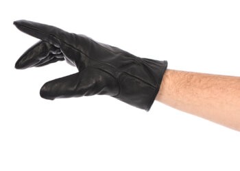 Man wearing black leather glove on white background, closeup right hand. Side view. High resolution photo. Full depth of field.