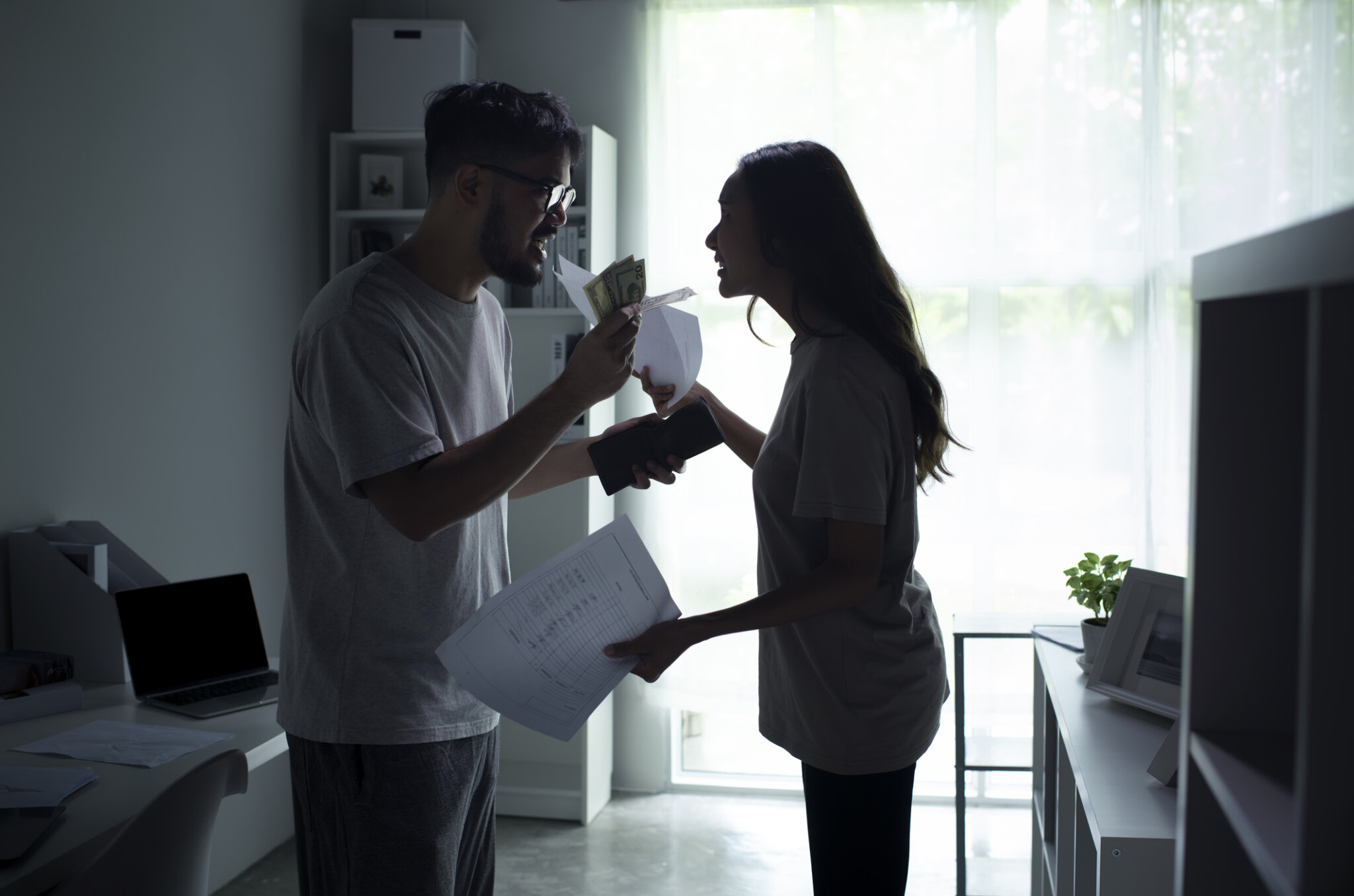 Asian couple arguing about money at home