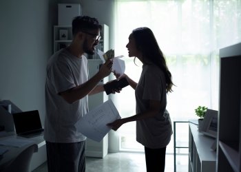 Asian couple arguing about money at home