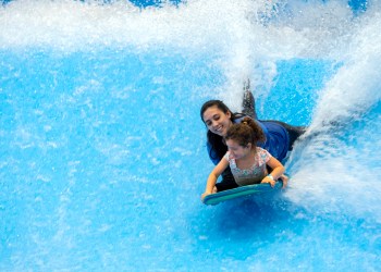 Kids riding the Scott's Pointe wave simulator