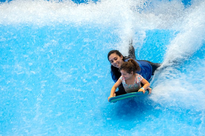Kids riding the Scott's Pointe wave simulator