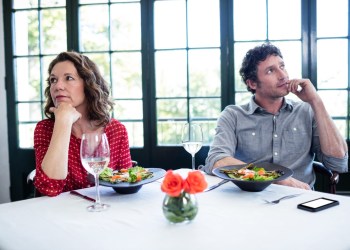 Woman feeling bored and ignoring each other in restaurant