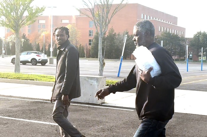 Rwandan genocide suspect Faustin Nsabumukunzi (right) and his son Thierry Balihuta outside federal court on Thursday