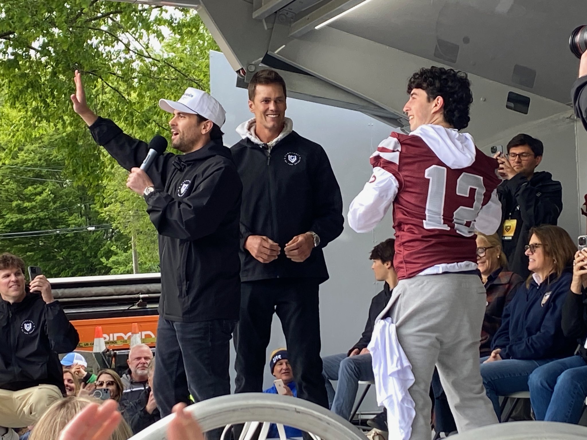 East Hamptons Bonacker quarterback Theo Ball throws out footballs with Tom Brady