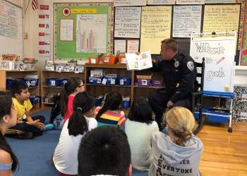 Southampton Town Det. Eric Breitwieser reads to third graders at the Tuckahoe School.