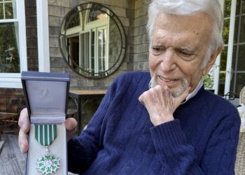 Ted Feder holding his award from the French Government.