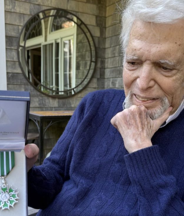 Ted Feder holding his award from the French Government.