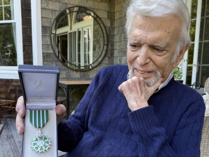 Ted Feder holding his award from the French Government.