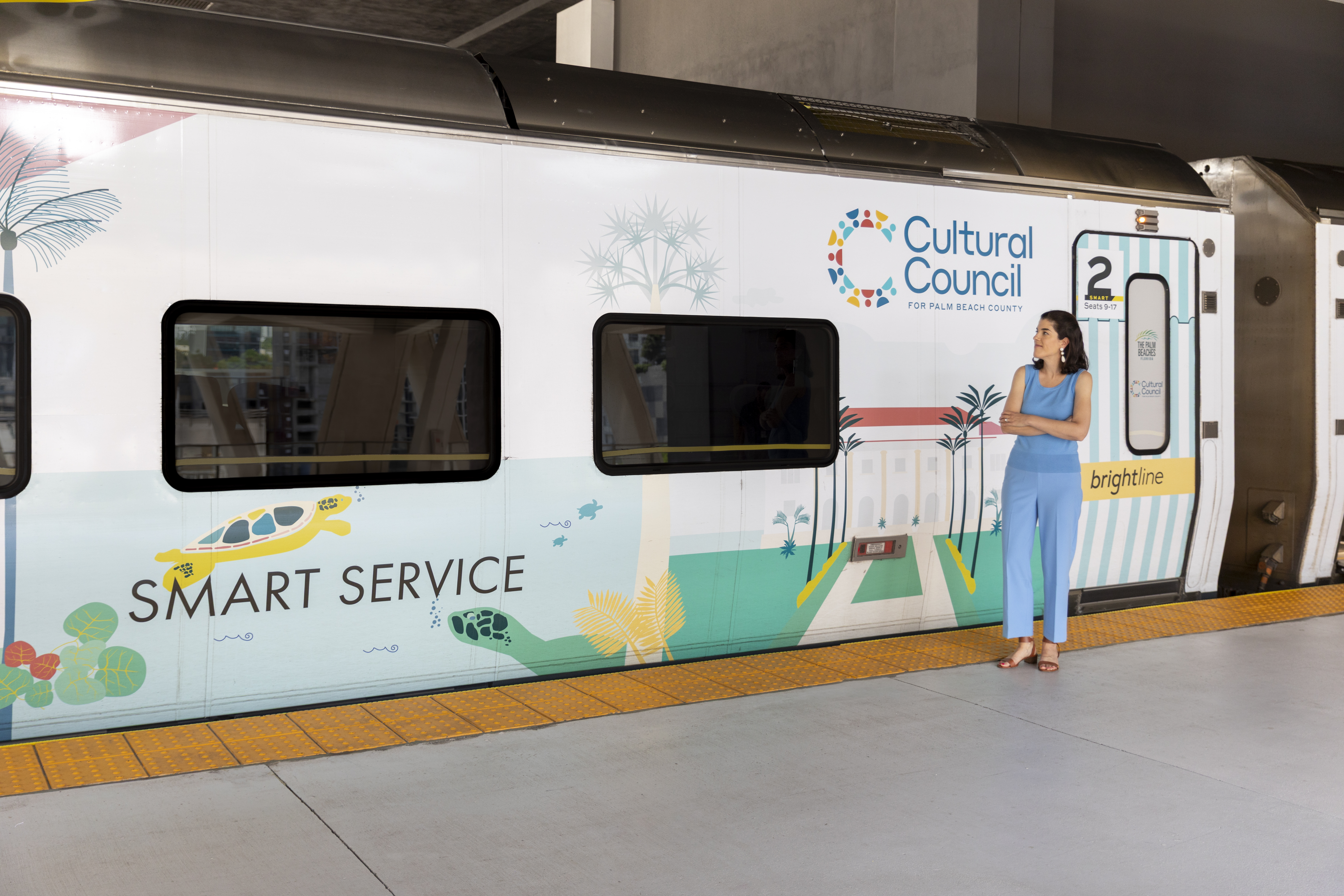 Artist Meghan Corrigan with her art wrapped Brightline train