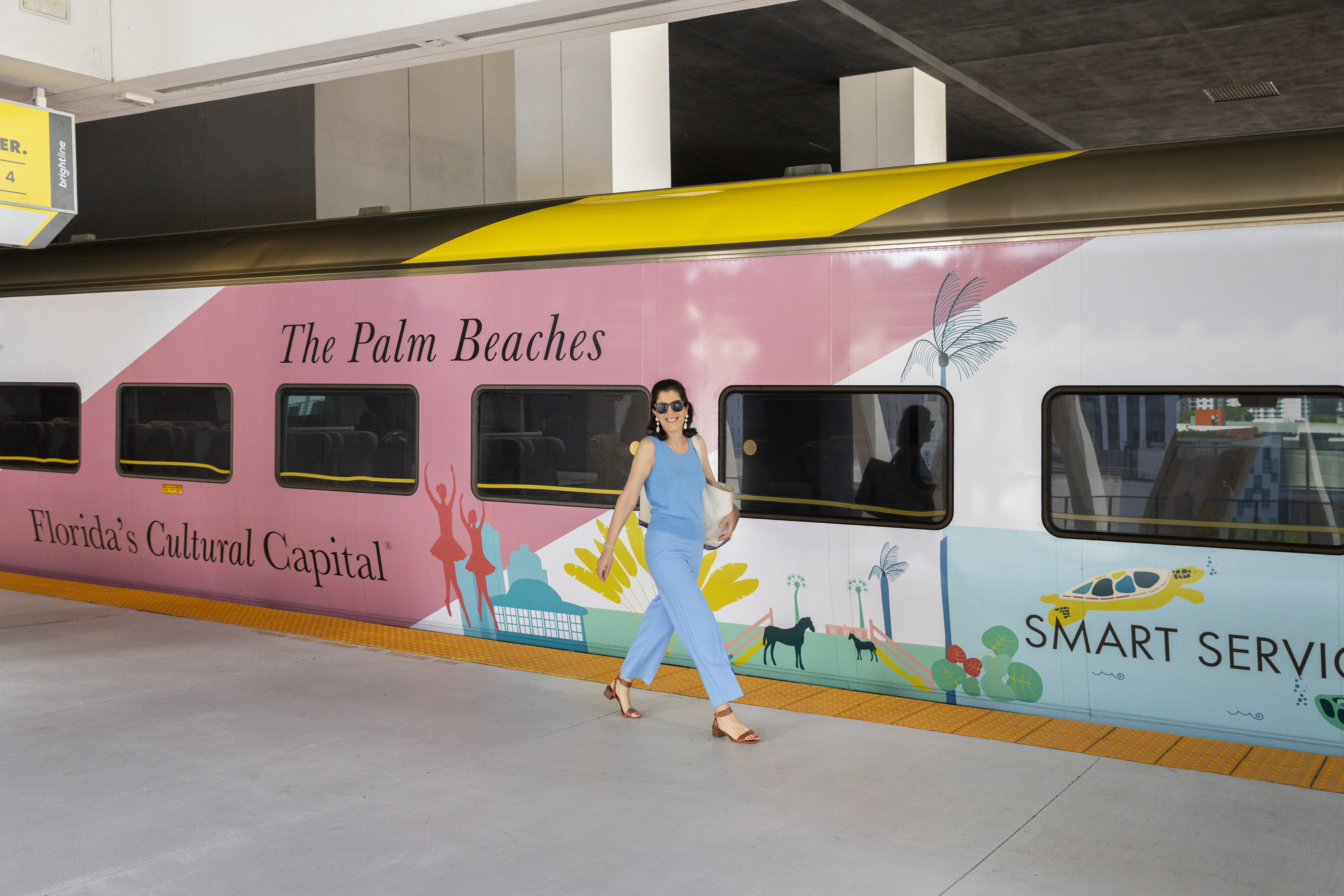 Artist Meghan Corrigan with her art wrapped Brightline train