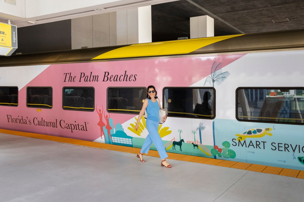 Artist Meghan Corrigan with her art wrapped Brightline train