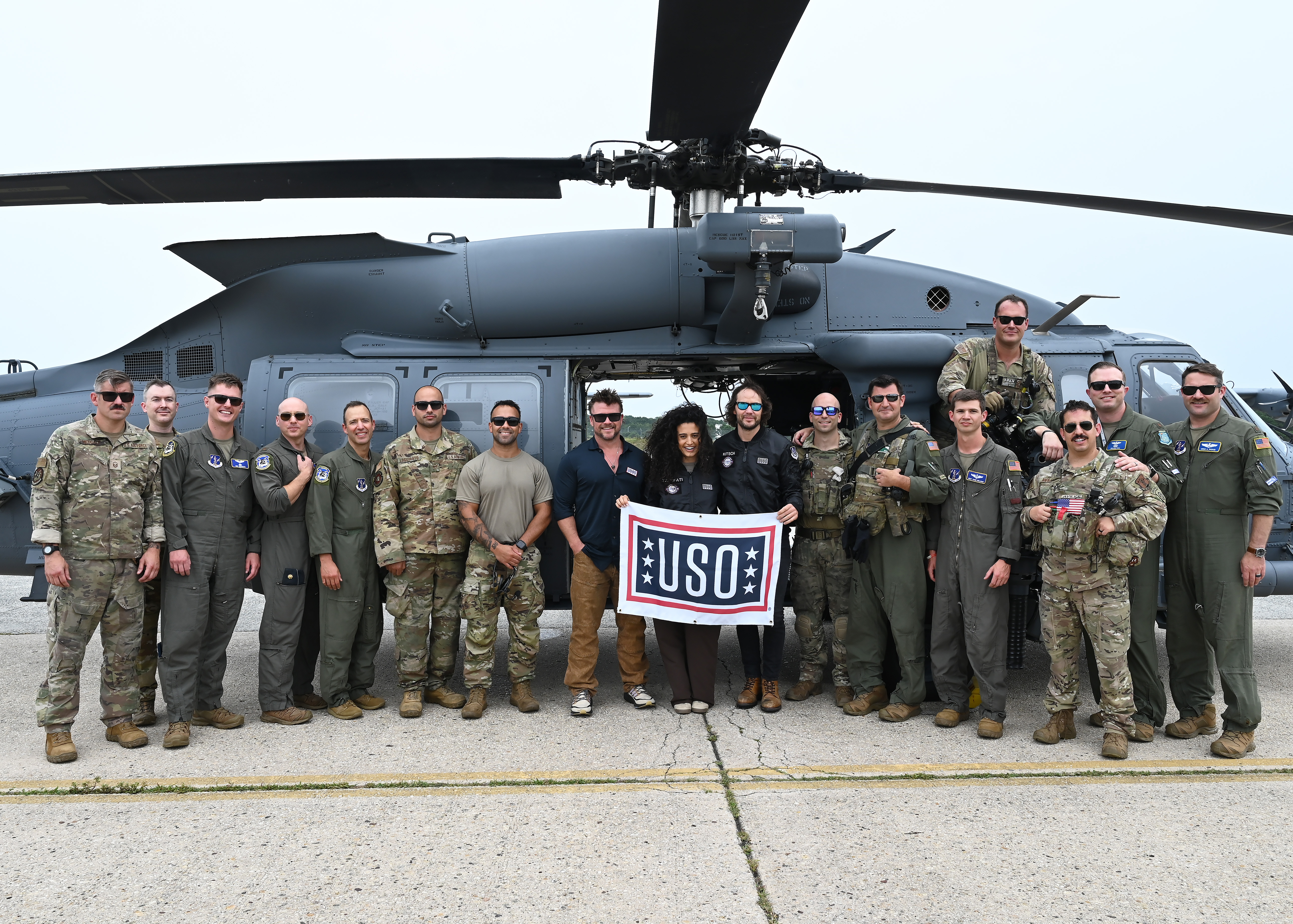 Luke Hemsworth, Shiraz Tzarfati and Taylor Kitsch pose for a photo with operators from the 101st and 102nd Rescue Squadrons assigned to the 106th Rescue Wing in Westhampton Beach, Tom Hopper and Jack Carr were also on the USO (United Service Organizations) sponsored visit to the base.