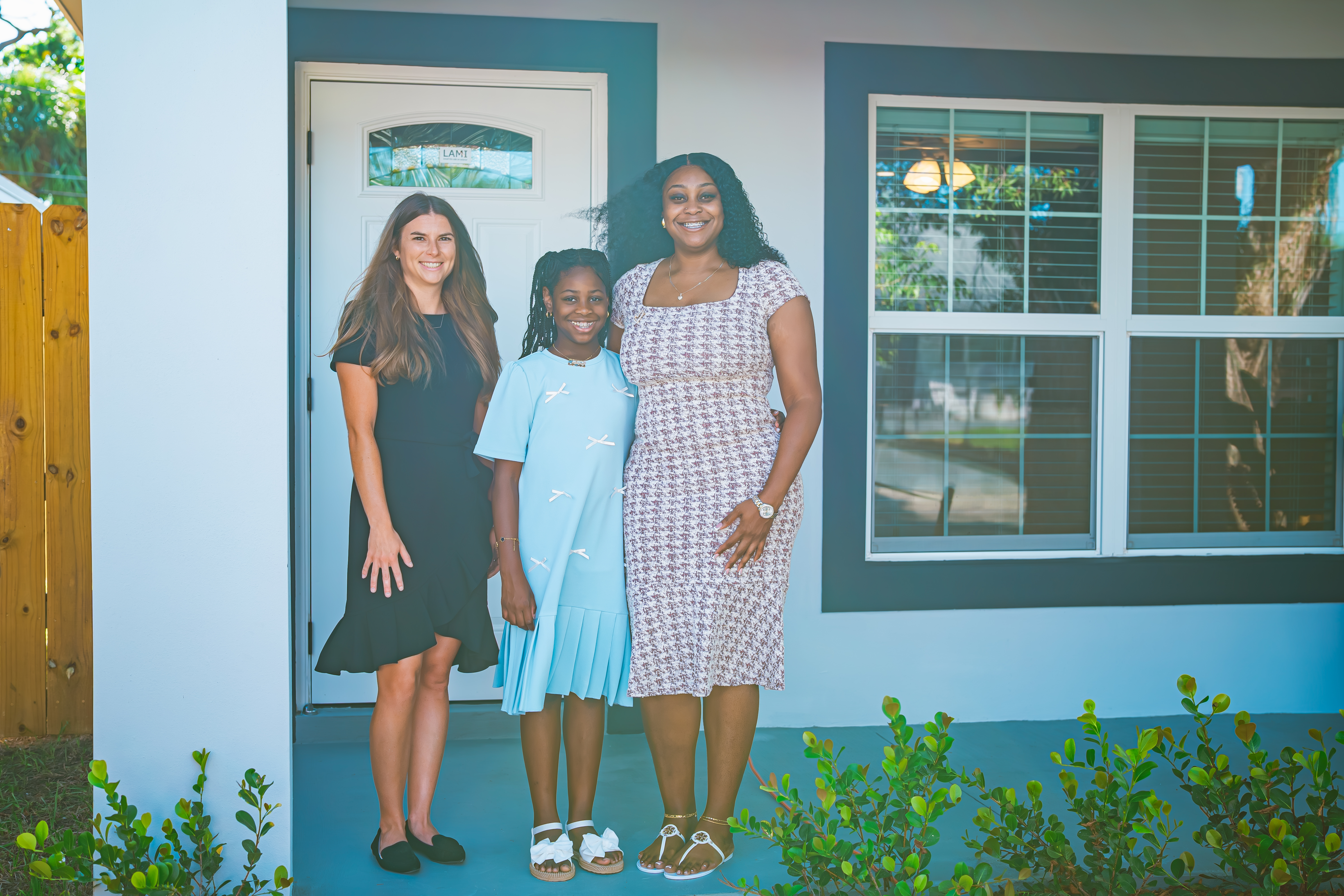 Julia McMahon , with homeowner Tangie Guillaume and daughter