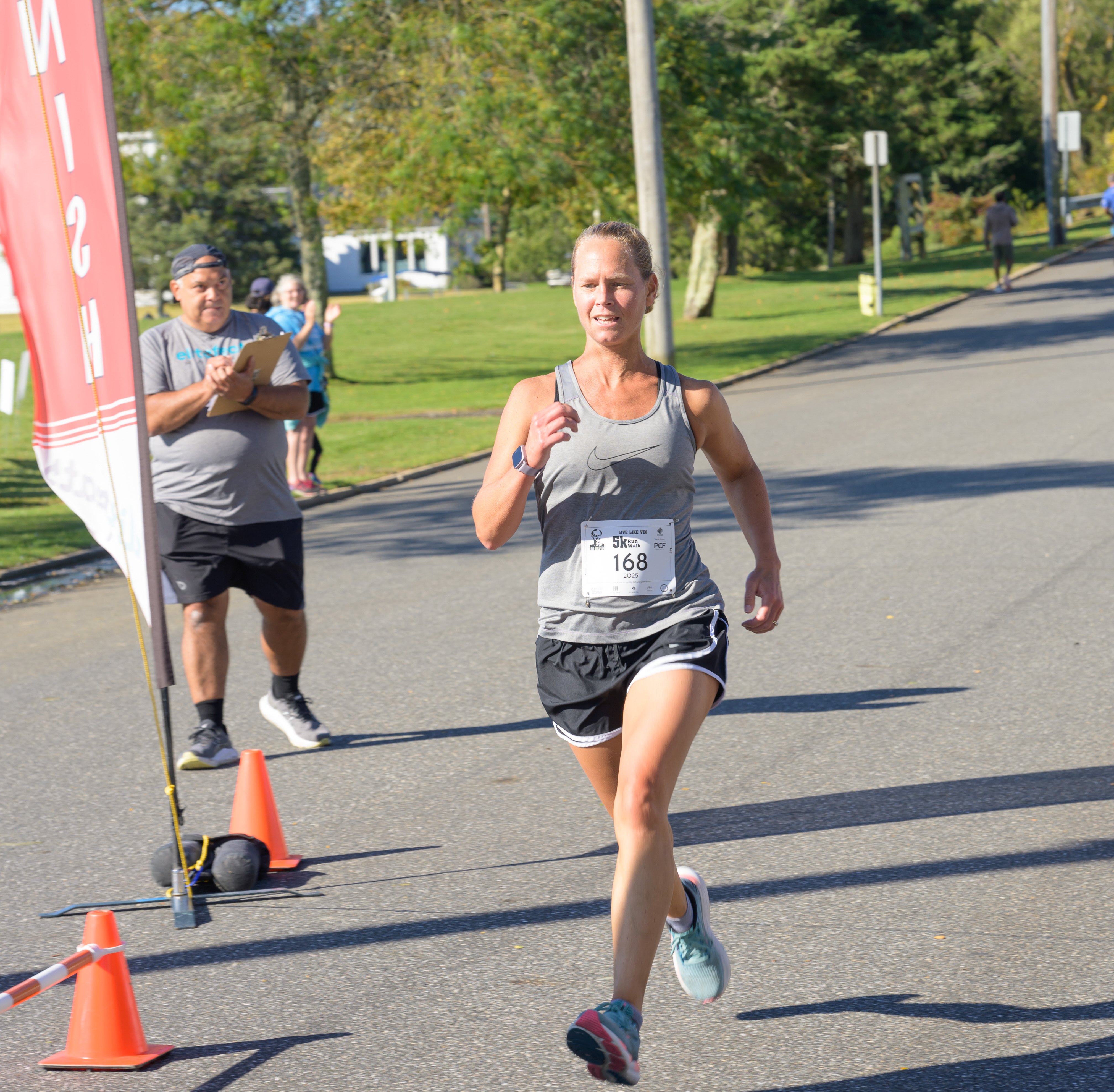 Amanda Clapp Third Place Female Runner Overall crossing the finish line
