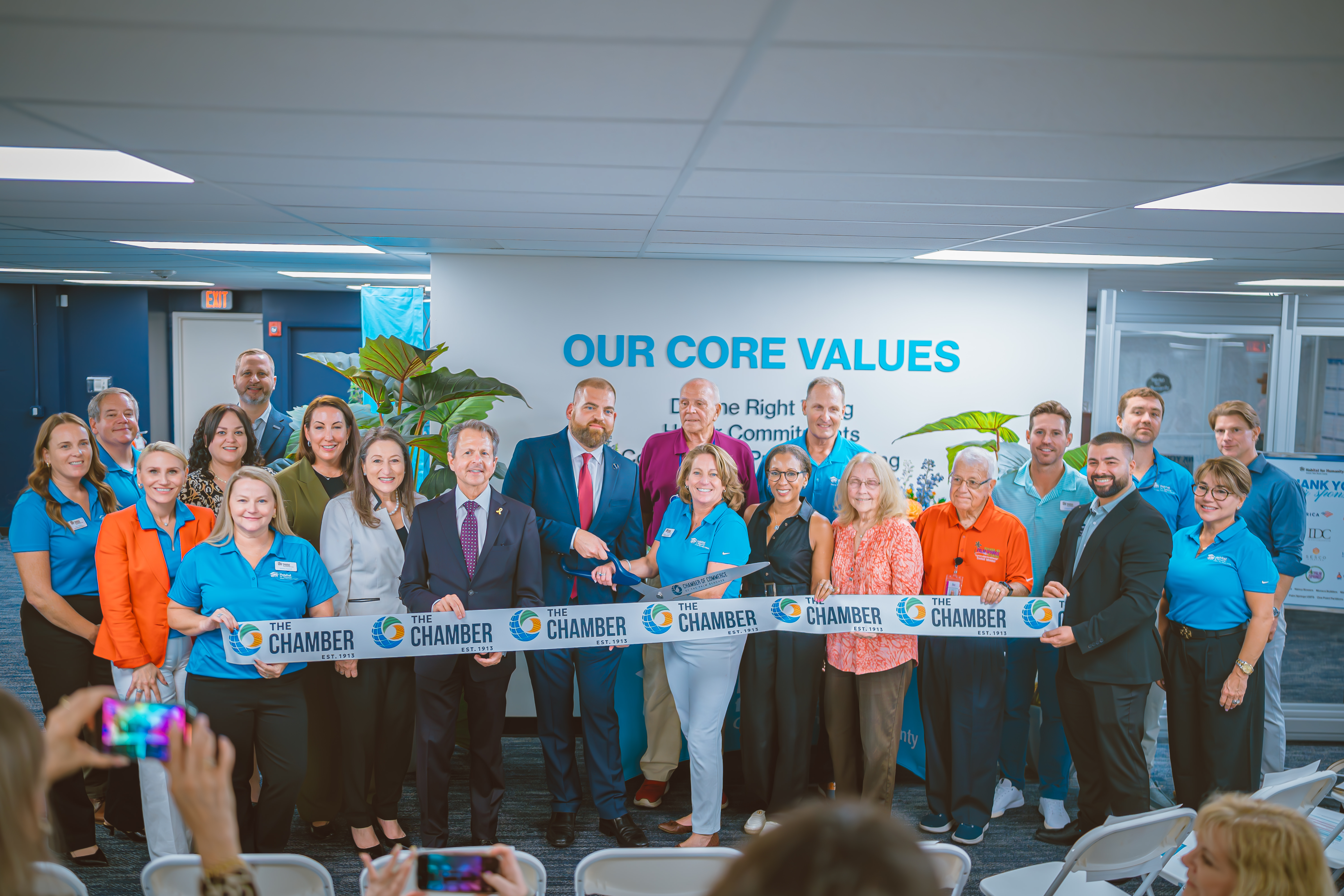Habitat GPBC staff, board, and supporters cut the ribbon at the new office with Michael Zeff,