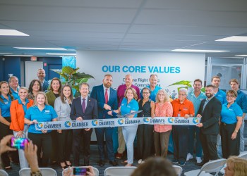 Habitat GPBC staff, board, and supporters cut the ribbon at the new office with Michael Zeff,