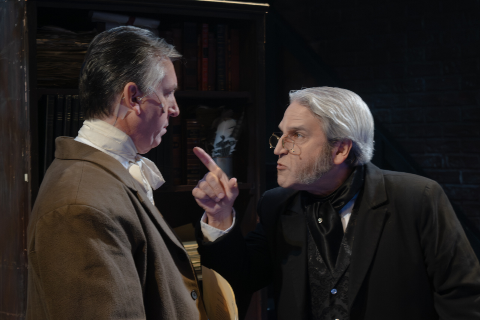 Ray Gobes, Jr. as Bob Cratchit and Jeffrey Sanzel as Scrooge in A Christmas Carol at Theatre Three