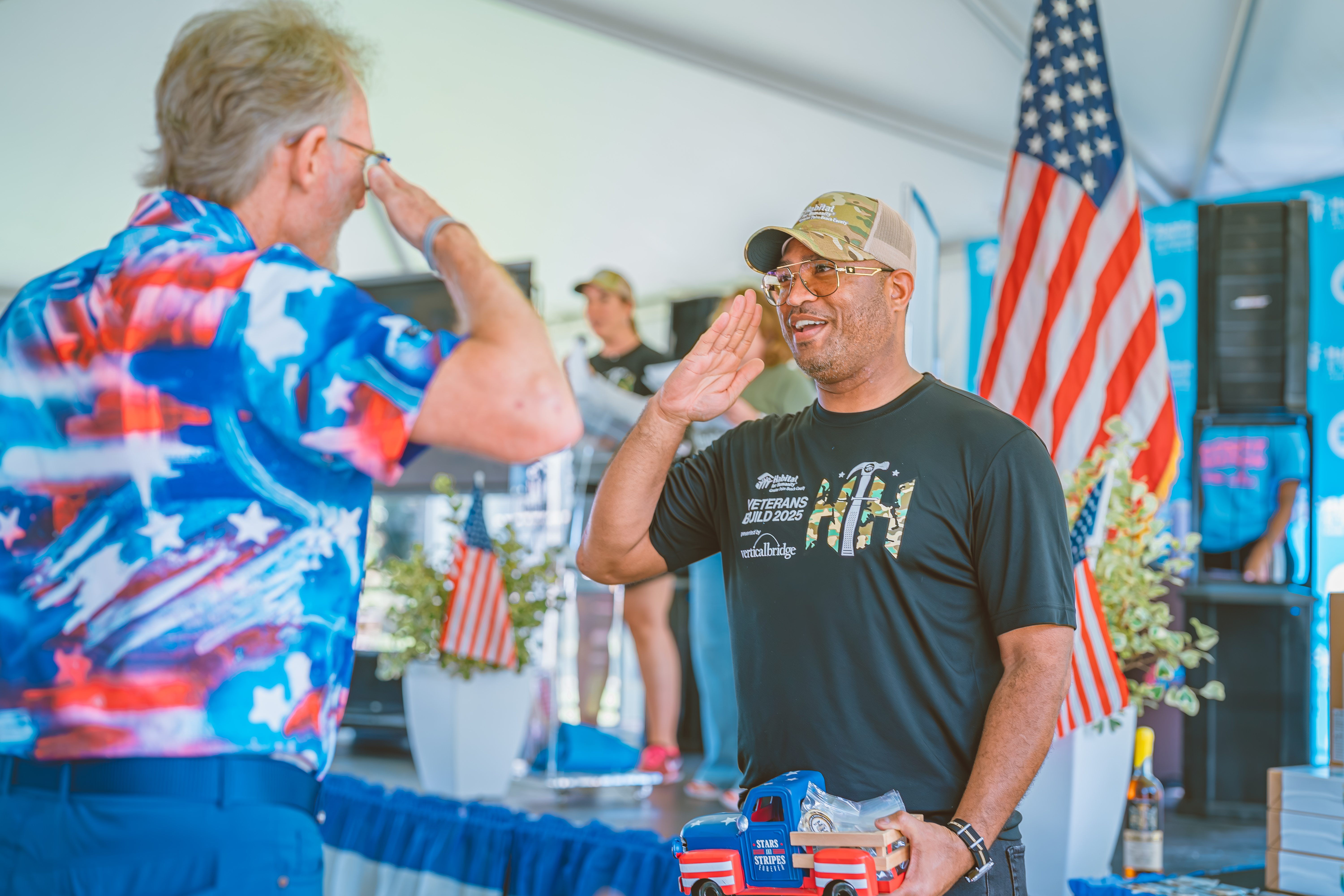Clint Lowe presenting veterans with custom Veterans Build challenge coins to honor their service.