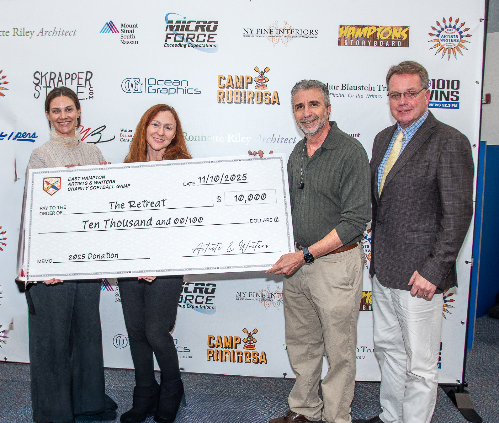 David Brandman and Mayor Jerry Larsen present check to Patricia Gallagher and Elise Trucks of The Retreat