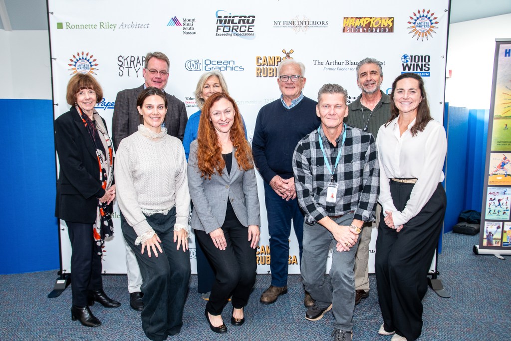 David Brandman and Mayor Jerry Larsen with representatives of the four organizations who are recipients of the donations from this year’s Artists & Writers Game