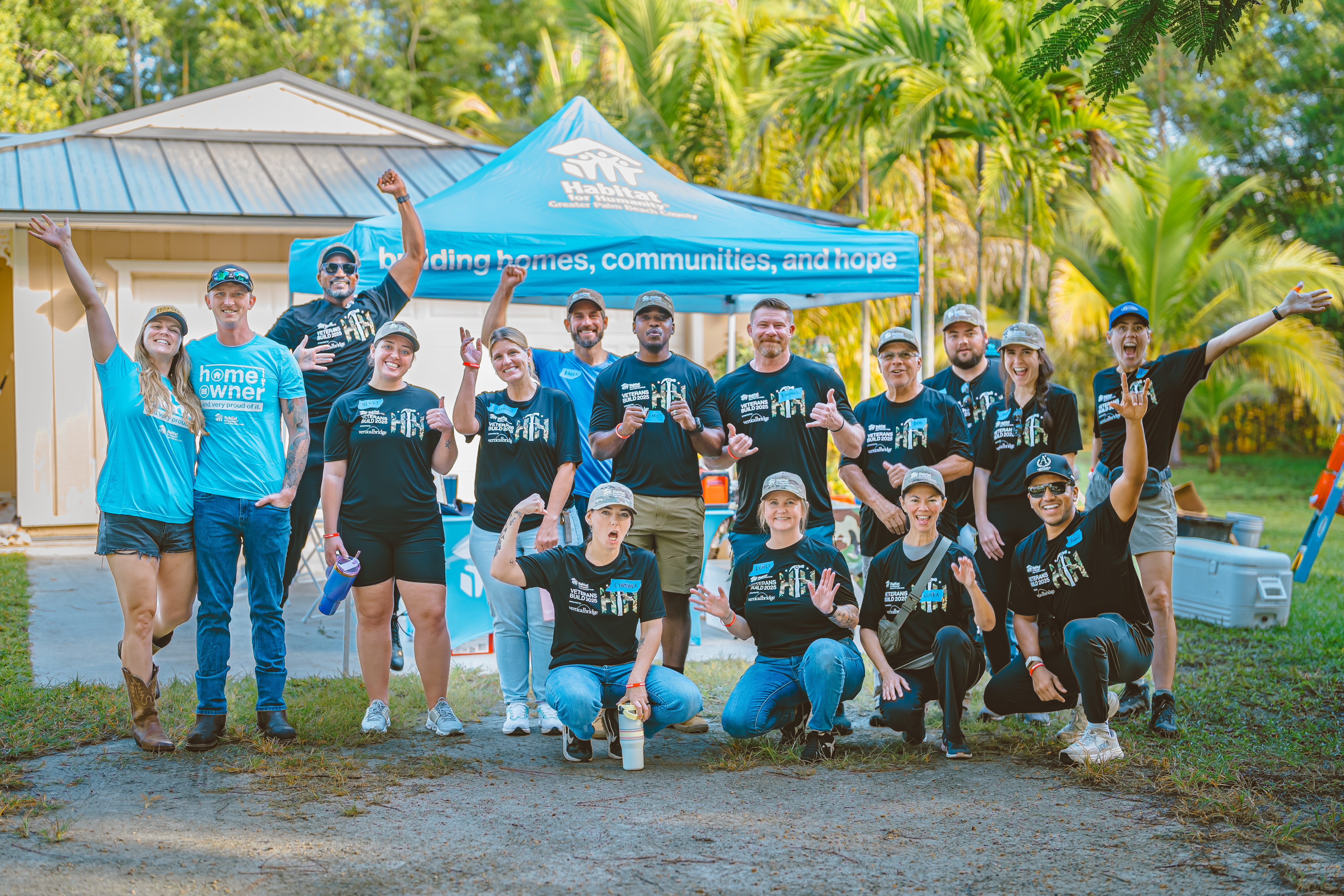 Homeowner Peter Allen  and his wife, with volunteers from Carrier, Gunster, Cleartouch, DSS Inc, and Starbucks who helped paint their home
