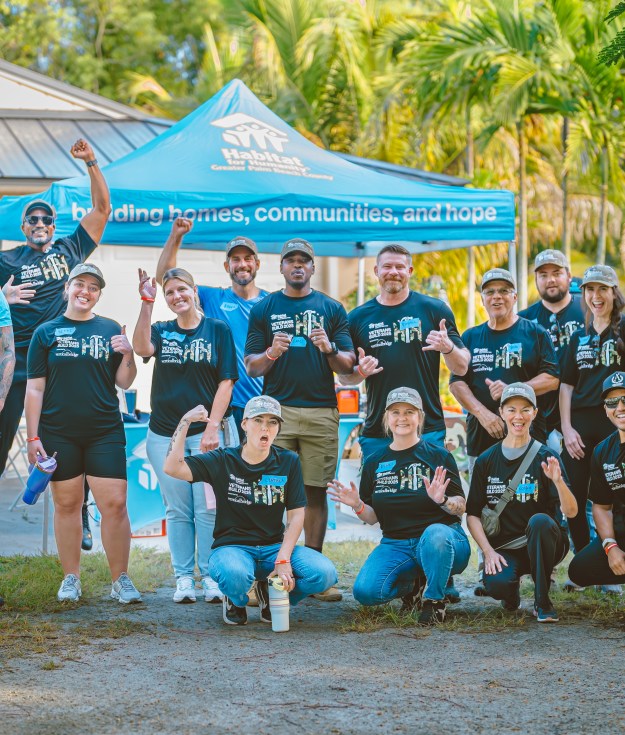 Homeowner Peter Allen and his wife, with volunteers from Carrier, Gunster, Cleartouch, DSS Inc, and Starbucks who helped paint their home