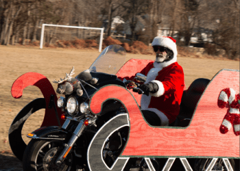 Santa Clause rides into Little Flower on a Harley.