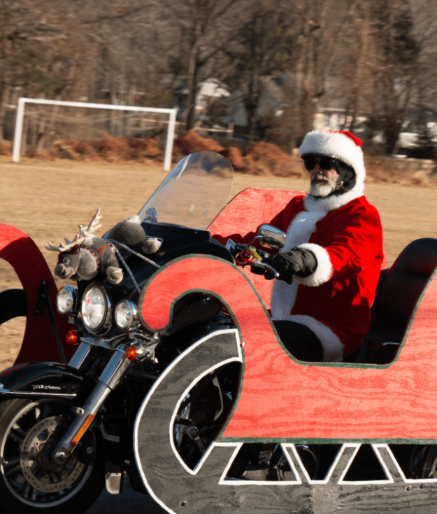 Santa Clause rides into Little Flower on a Harley.