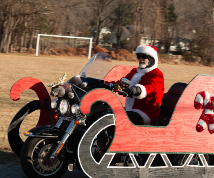 Santa Clause rides into Little Flower on a Harley.