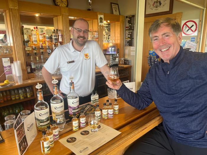 Bill McCuddy sampling local whiskey while playing golf in Ireland