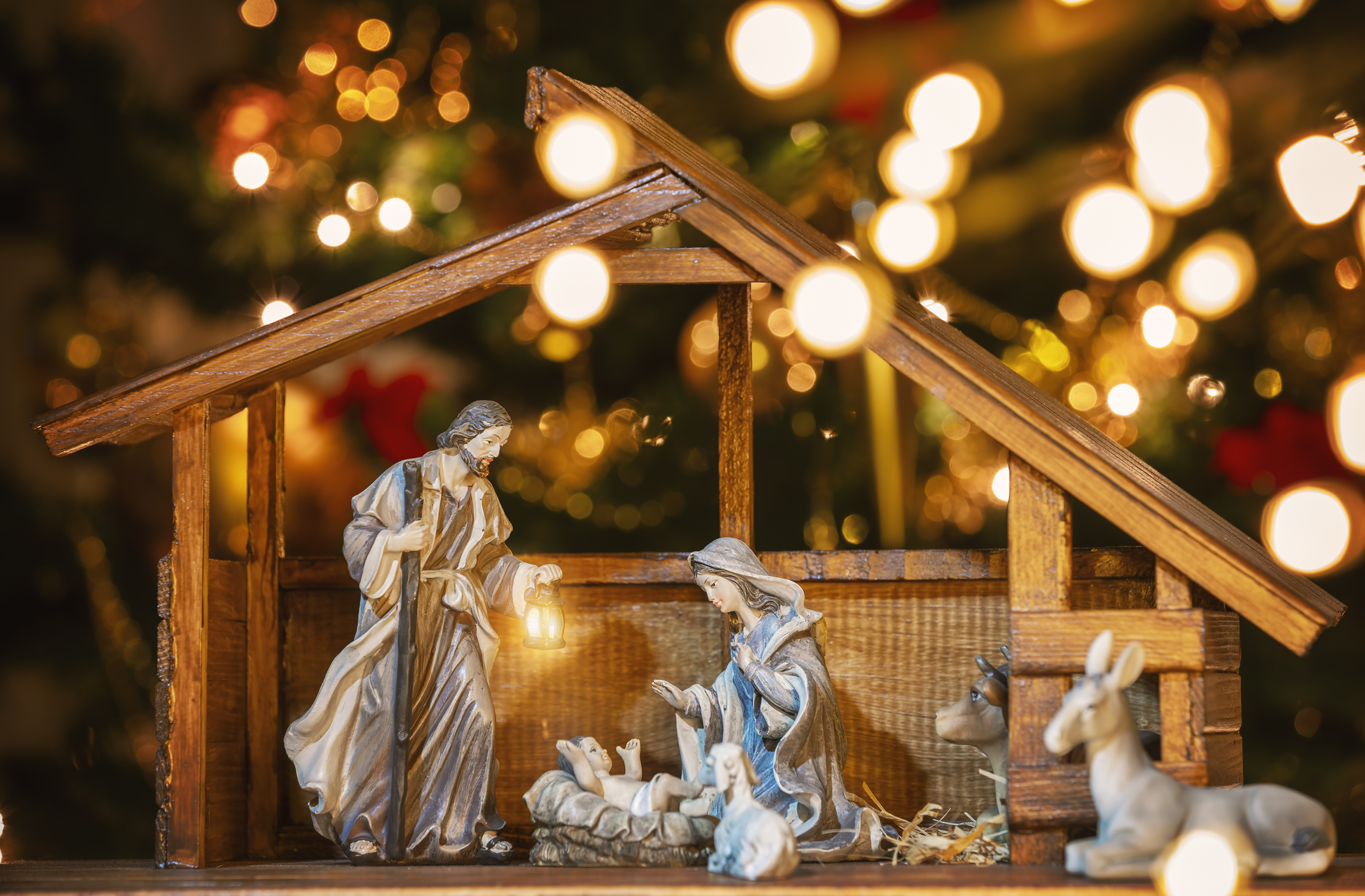 Christmas Manger scene with figurines including Jesus, Mary, Joseph and sheep. Focus on mother!