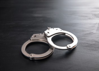 handcuffs on wooden background