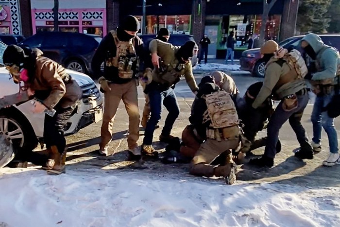 The moment that the firearm of a man identified as Alex Pretti is retrieved from a waistband holster by a federal officer (in light grey jacket, crouched) as another officer (in green) draws his weapon, before Pretti was fatally shot in Minneapolis, Minnesota, U.S., January 24, 2026 is seen in a still image of a video obtained by Reuters. VIDEO OBTAINED BY REUTERS/via REUTERS  THIS IMAGE HAS BEEN SUPPLIED BY A THIRD PARTY. NO RESALES. NO ARCHIVES. AN UNCROPPED AND UNPROCESSED VERSION HAS BEEN PROVIDED SEPARATELY.   VERIFICATION LINES: Reuters was able to verify the location and date of the videos from original file metadata. Buildings, road layout, trees and utility poles which matched file and satellite imagery of the place. The Department of Homeland Security said one of his agents fired shots in Minneapolis, Minnesota on Saturday (January 24). Minnesota Governor Tim Walz confirmed a shooting by federal agents took place on Saturday (January 24).