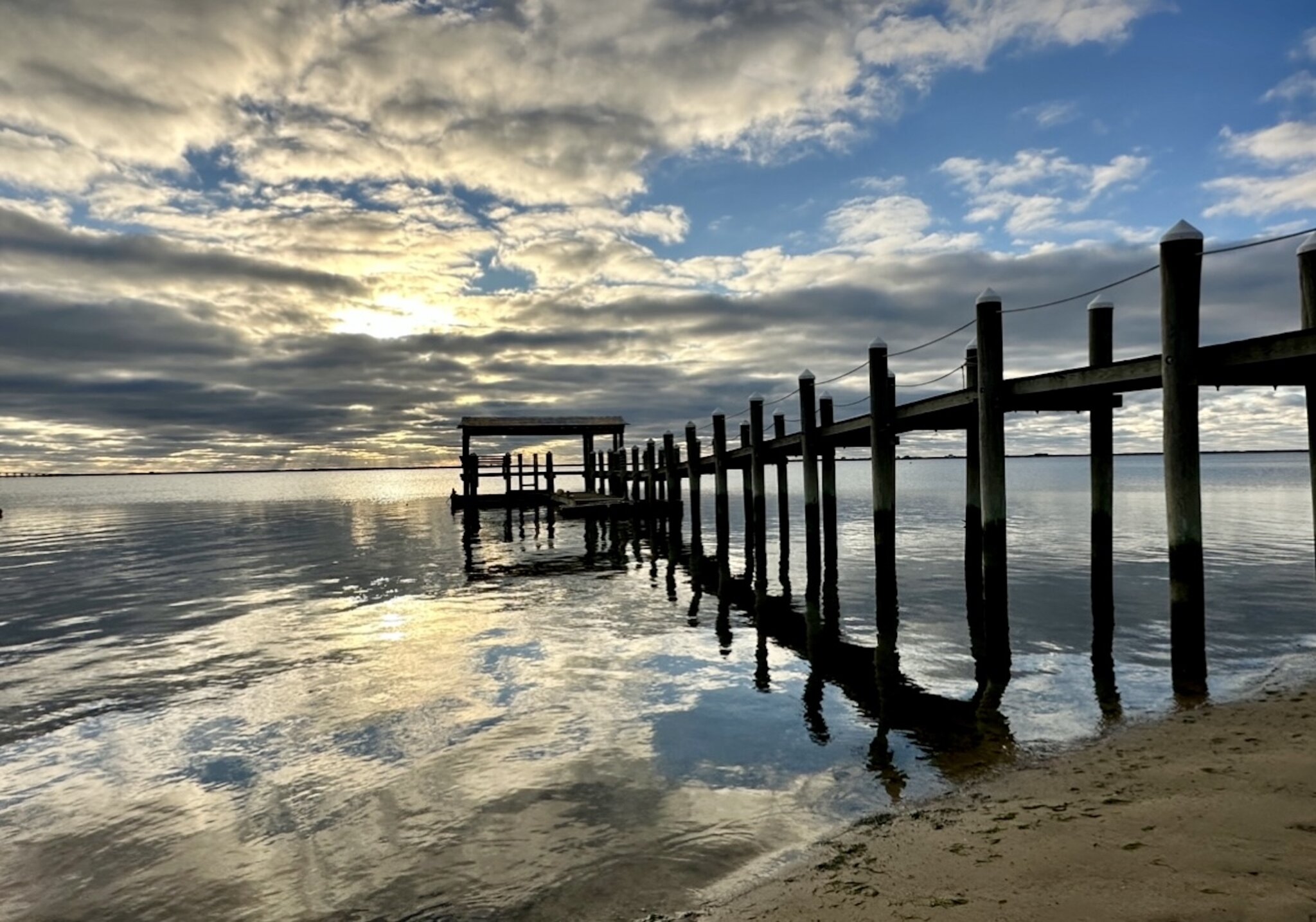 “Clouds Surround the Rising Sun … a New Day is Born” in East Quogue, photo taken by Lucille Corva