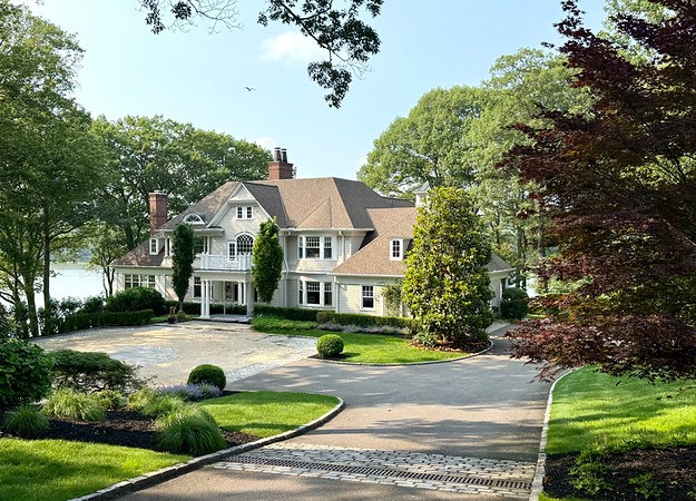 Waterfront Hamptons style house photo, and one below it with the porch, showing the water and dock or town of Huntington